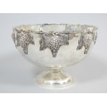 Silver plated punch bowl, the rim decorated with grapes and vines, raised on a circular foot, 37cm.