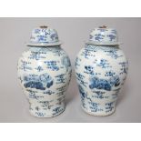 Pair of Chinese blue and white vases with covers, of baluster form and decorated with dragons,