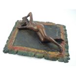 Austrian style cold painted bronze, modelled in the form of a woman reclining on a Persian rug,
