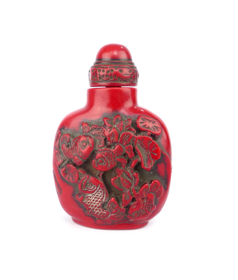 Chinese red snuff bottle carved with koi carp fish, 7.8cm h.