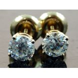 Pair of 18ct yellow gold diamond solitaire ear studs, screw back fitting, total weight 1.30ct.