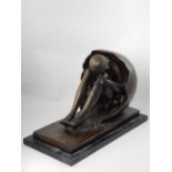 A bronze in the manner of Bruno Zach, Choesterol, woman emerging from an egg, bronze,