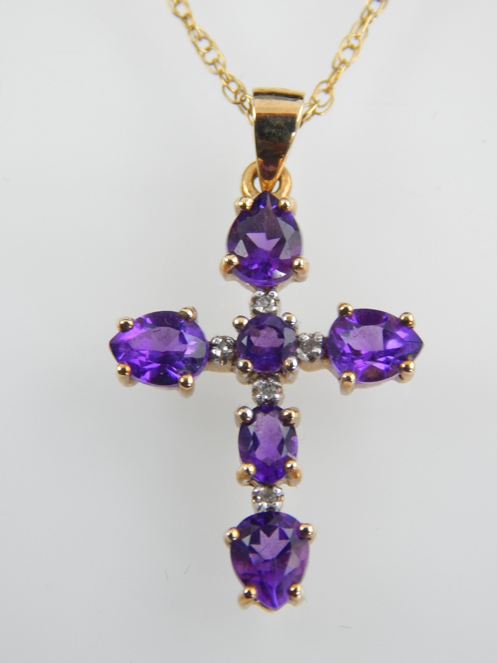 9ct yellow gold amethyst cross pendant on 9ct fine chain.