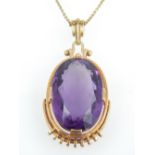 Amethyst pendant, the oval cut stone within a yellow metal frame, on a 14ct gold chain, 17.