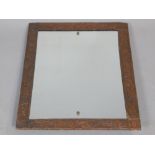 Arts & Crafts rectangular mirror, beaten copper surround, floral decoration, 62 x 52cm.