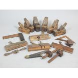 Collection of vintage carpentry planes and other woodwork tools.
