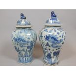 Pair of Chinese octagonal baluster shaped lidded vases, decorated with fish, 57cm h,