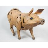 Aged metal garden ornament of a standing pig, 90 cm.
