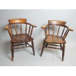 Near pair of smoker's bow elbow chairs, elm, turned supports and saddle seats,