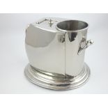 Plated single bottle wine cooler with hinged ice compartment on oval foot.