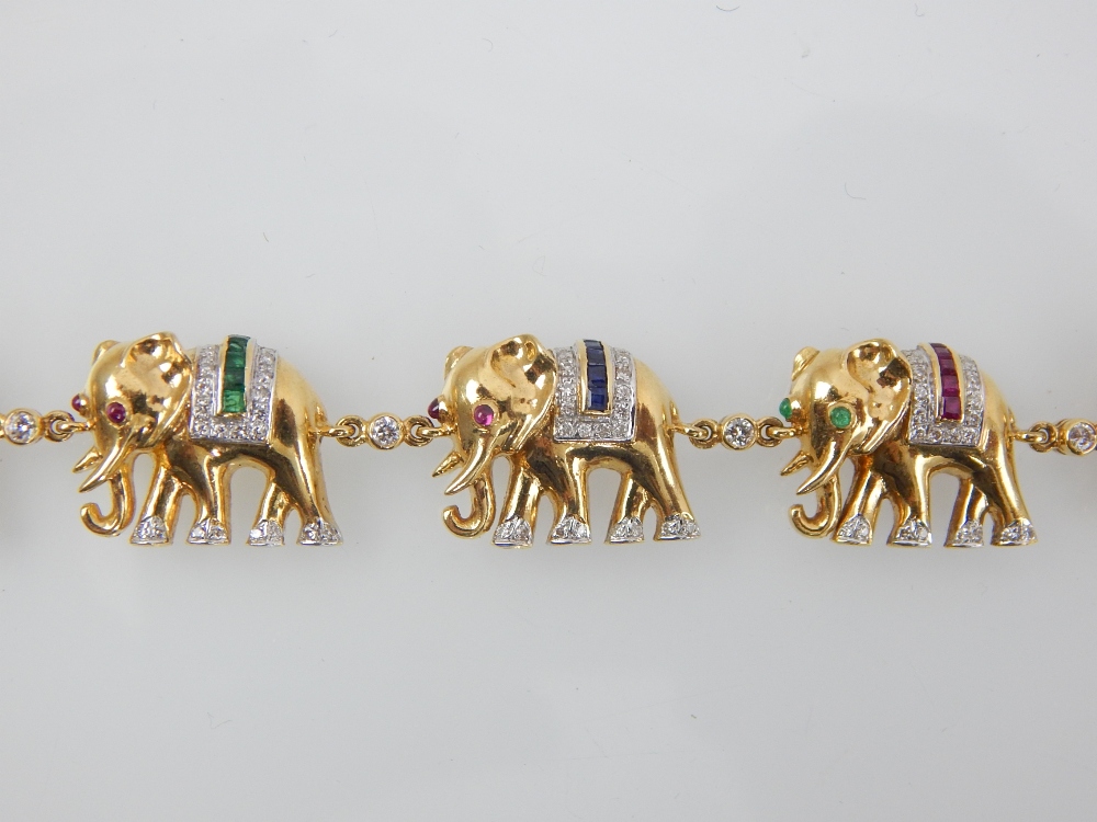 A diamond, ruby, emerald and sapphire set bracelet in 18ct yellow. - Image 2 of 2