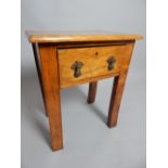 A continental fruitwood lamp table with deep frieze drawer raised on rectangular section legs,