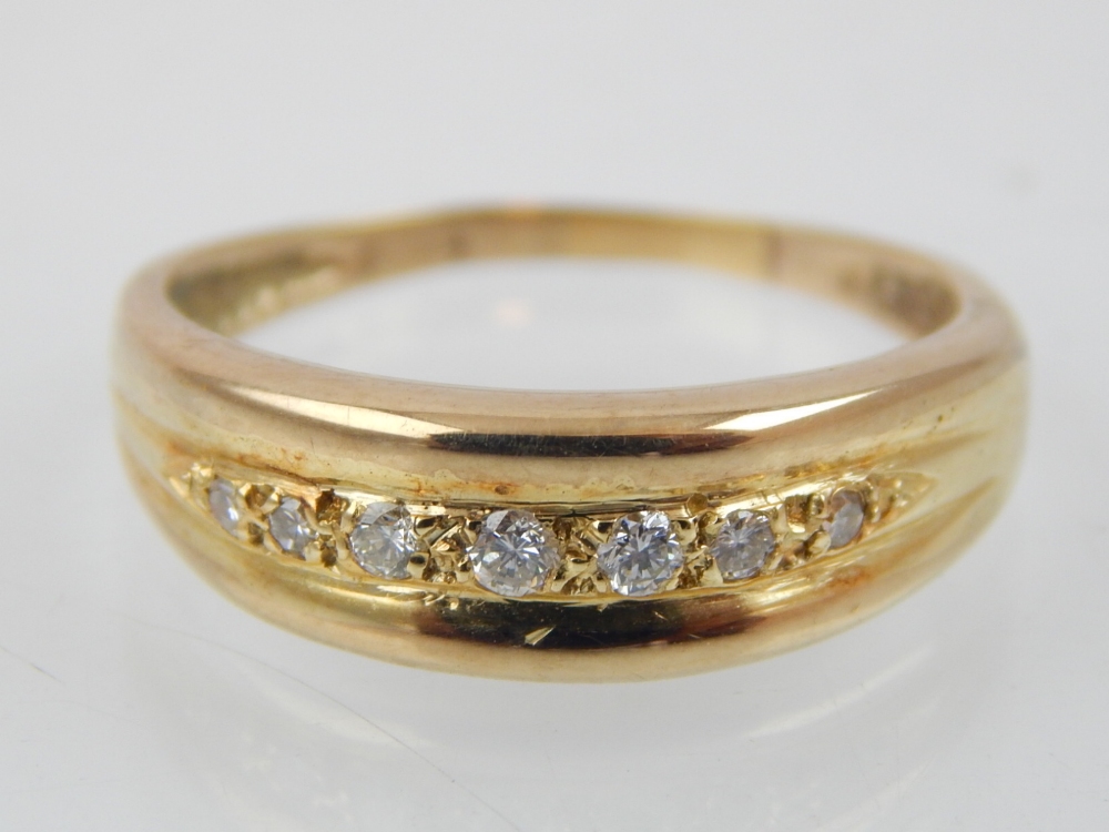 Ladies dress ring, 7 graduated diamonds, 9ct gold setting.