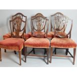 Six mahogany dining chairs of Hepplewhite style, shield backs, swag and urn splat,
