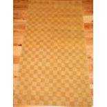 Turkish part silk and wool rug, of honey ground chequer design, 93 x 158cm.
