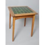 An Arts & Crafts oak and green tiled square topped table, 74 x 61 x 61cm.
