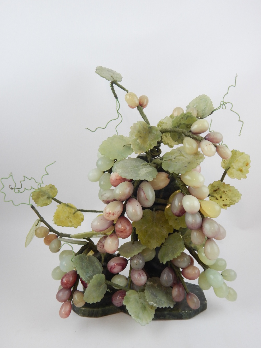 Chinese hardstone carving modelled as a bunch of grapes, 30cm h.
