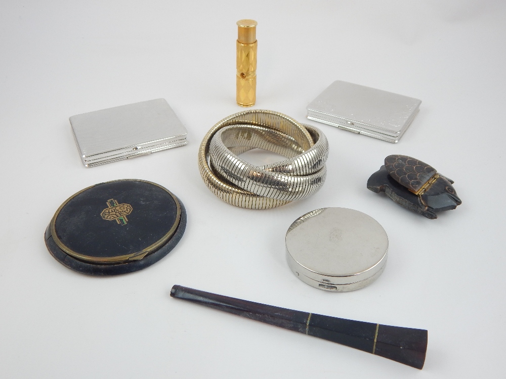 Collection of compacts, lipstick holder, cigarette holder and expanding bangle bracelet.