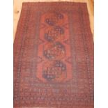 Bokhara rug, with large elephant pad medallions to centre over red ground, reticulated borders,