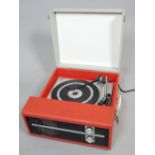 Vintage grey and red vinyl covered portable record player.