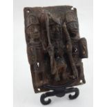 An unusual bronze Benin style plaque depicting three warriors, 18cm h.