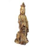 A late 19th/early 20th C Chinese carved soapstone figure of an immortal with russet staining, 28cm