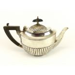 Victorian silver hallmarked teapot of neoclassical boat form, the lid and body part reeded, ebonised