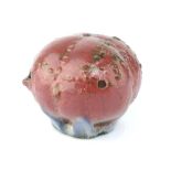 A Korean underglazed blue and copper-red Yi Dynasty porcelain water dropper modelled as a peach with