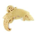 A carved and pierced white jade Chinese fish dragon pendant decorated with ''sleeping silkworm