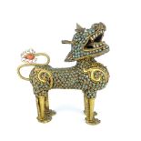 A highly decorative Sino-Tibetan gilt metal temple lion studded with blue cabouchon stones, 14 x