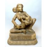 A carved exotic wood group of Poonam and Lord Krishna, 70cm high.