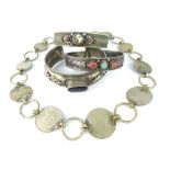 Three antique Sino-Tibetan white metal bangles and an Indo-Chinese coin bracelet. (4)