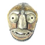 An antique Bhutanese Kapala, the mask of skull bone fragments is mounted with white metal