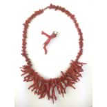 A naturalistic coral necklace comprising a single strand of coral pieces of various natural forms,