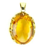 A large citrine / Cairngorn pendant claw set in yellow gold,