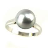 A cultured pearl ring the single 9.2mm pearl of greyish white colour, mounted in a white metal band.