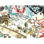 A large, miscellaneous collection of costume jewellery including brooches, pendants, necklaces,