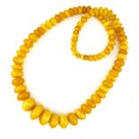 An exceptional natural Baltic amber bead necklace comprising eighty three polished amber beads of