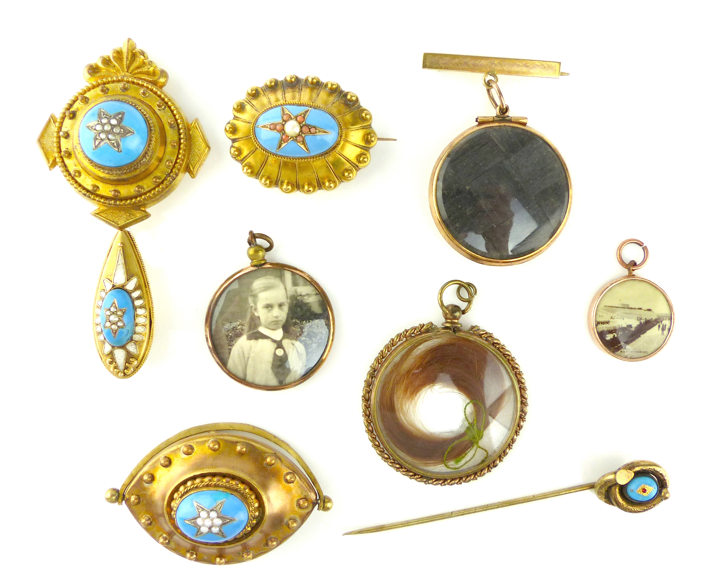 A collection of antique mourning jewellery to include thirteen clear glass lockets,