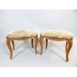 Pair of Louis XVI style stools, the rectangular pad seats above cabriole legs caved with flowers and