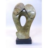 In the manner of Barbara Hepworth, an abstract green marble sculpture, monogram BH, on ebonised