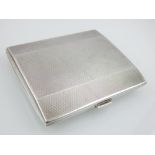 Silver cigarette case, London 1932, of rectangular form with engine turned covers and gilt interior,