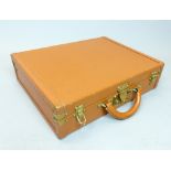 A Louis Vuitton grained tan leather attache case with bronze mounts and locks (Louis Vuitton made in