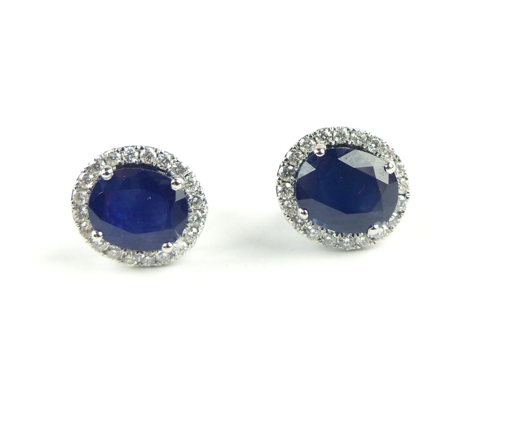 Pair of sapphire and diamond set ear studs, the oval central stone set within a girdle, the posts