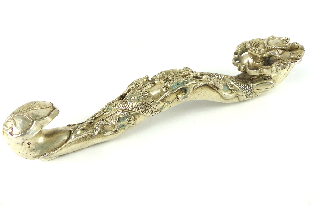Chinese white metal ruyi sceptre cast as a dragon, 28cm