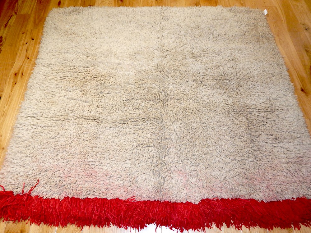 Tibetan blanket, natural coloured long pile with a red band to one end, 180 x 150cm