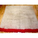 Tibetan blanket, natural coloured long pile with a red band to one end, 180 x 150cm