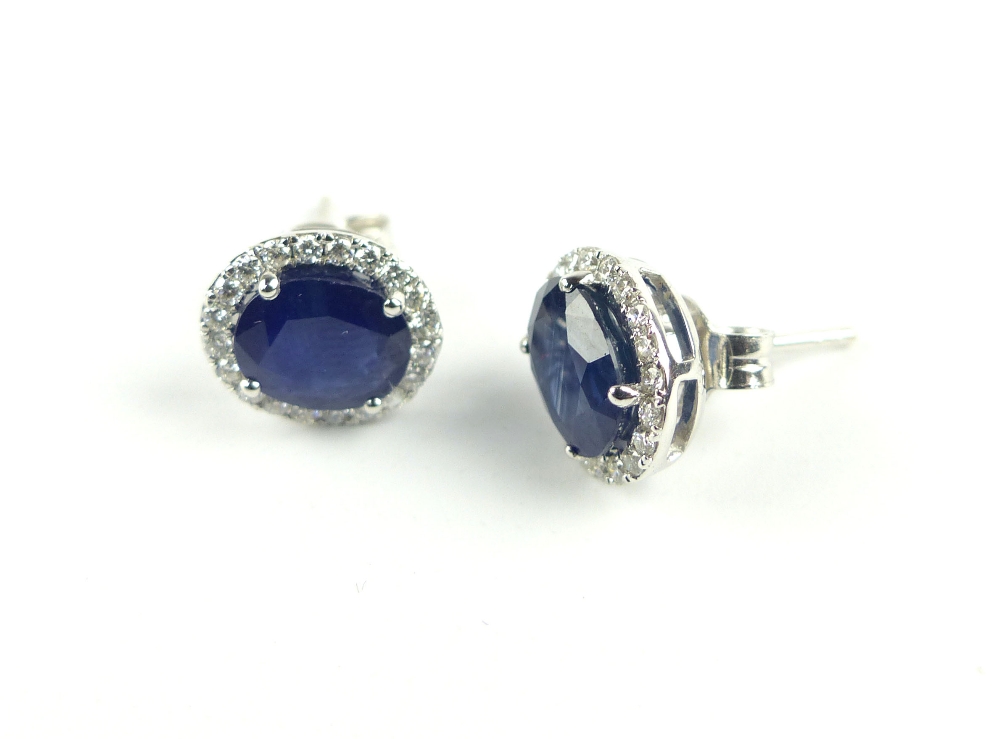 Pair of sapphire and diamond set ear studs, the oval central stone set within a girdle, the posts - Image 2 of 2