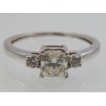 18ct white gold diamond dress ring, central cushion cut diamond of 1ct, flanked by two other