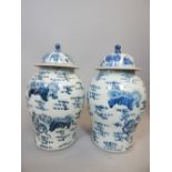 Pair of Chinese blue and white baluster with covers, of baluster form and decorated with dragons